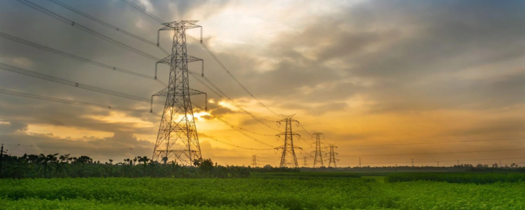 Power transmission lines against a dramatic sunset landscape