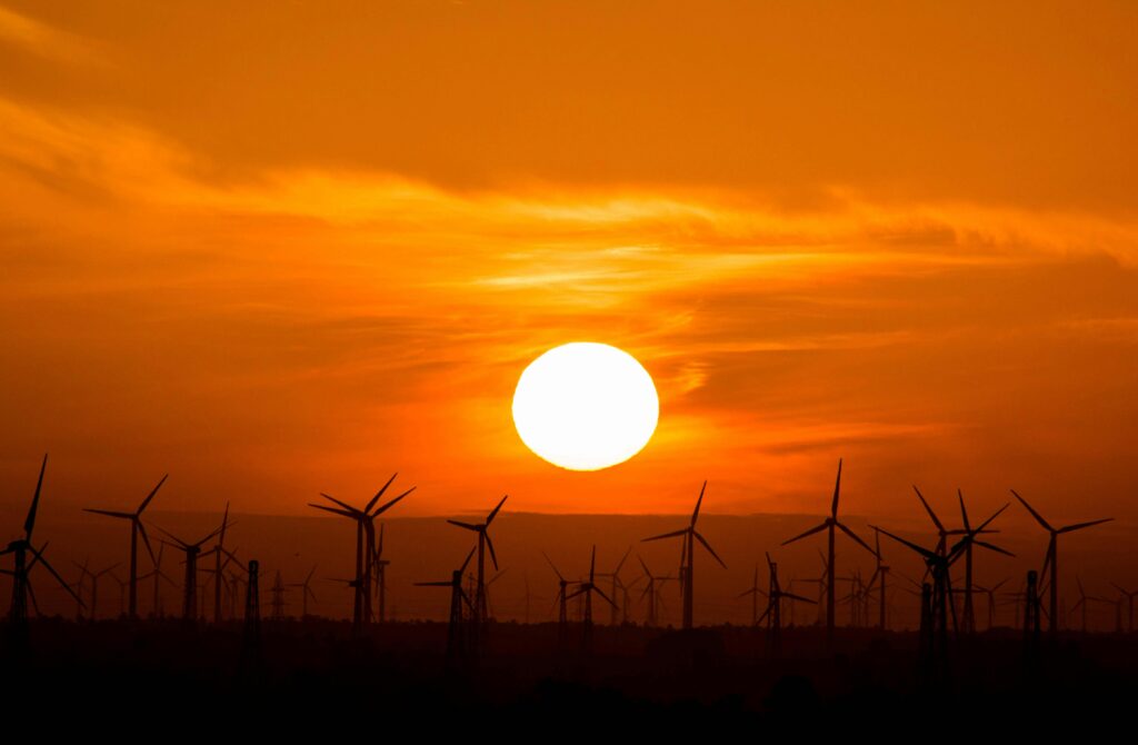 Large-scale wind farm against a vibrant sunset